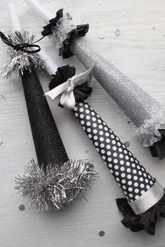 some black and white items are laying on the floor together with silver tinsels