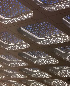 the ceiling is made up of many different shapes and sizes, with blue sky in the background