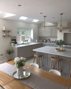 a kitchen filled with lots of counter top space and white appliances on top of it