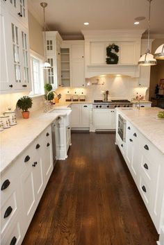 the kitchen is clean and ready for us to use it's white cabinetry