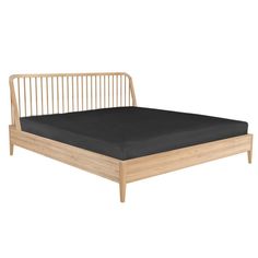 the bed frame is made from wood and has black sheets