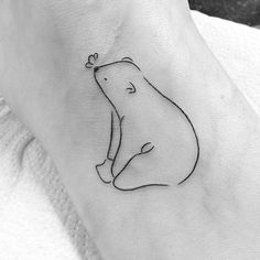 a small bear tattoo on the ankle