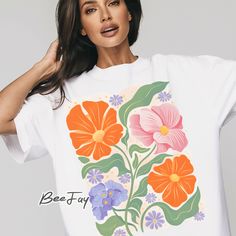 a woman wearing a t - shirt with flowers on it