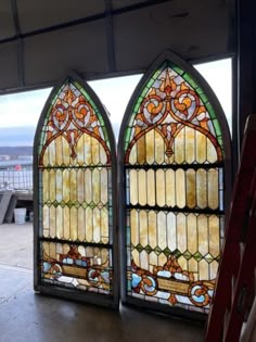 two stained glass windows sitting inside of a building