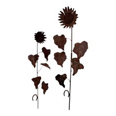 three metal sunflowers and two leaves on a white background