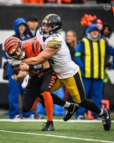 a football player is being tackled by another player