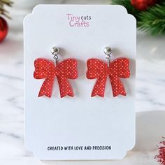 These Christmas red bow earrings are perfect for the holiday season, featuring a festive red bow with polka dots. Lightweight and playful, they add a charming touch to your Christmas outfits, whether you're attending a party or celebrating with family. A thoughtful gift for her, these earrings make a stylish and fun accessory for the winter season.  Made with high quality acrylic and stainless steel findings for sensitive ears, with two choices: hooks or ball posts in gold tone or silver. Measuring 1.12 to 1.24 inches, these earrings are a great addition to any festive collection. Earrings come in a gift bag with a polishing cloth:) safely packaged in a shipping box.  Please contact me with any questions. Bow Earrings For Valentine's Day Gift, Red Earrings For Christmas Gift, Cute Red Christmas Earrings, Cute Red Earrings For Christmas, Thoughtful Gifts For Her, Festive Collection, Holiday Earrings, Christmas Outfits, Earrings Christmas