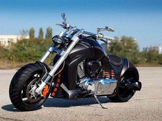 a black motorcycle parked on top of a parking lot