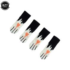 three pairs of socks with black and white designs on them, one has an orange cat