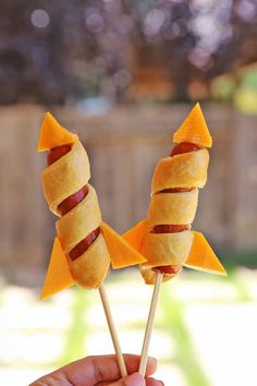 a person is holding some food in their hand with the words fourth of july rocket dogs on it