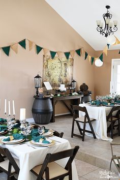 a dining room filled with lots of tables covered in white and green table cloths