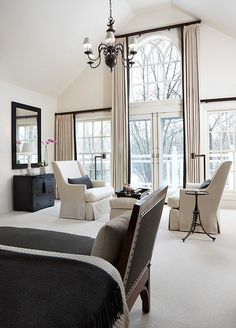 a living room filled with furniture and a chandelier