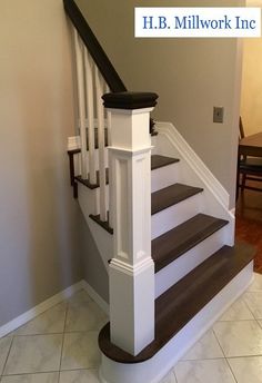 the stairs are painted white and brown in this home's entryway, which also has tile flooring