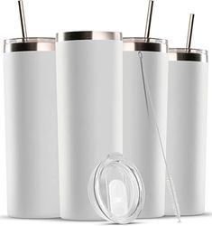 three white tumblers with straws in them next to an electric toothbrush holder