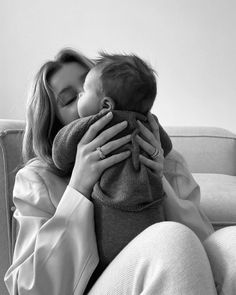 a woman holding a baby in her arms