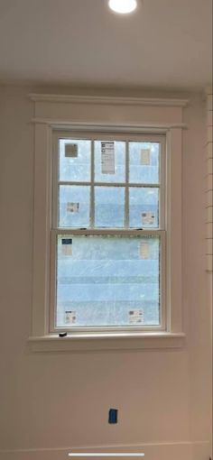 an empty room with a window and no curtains on the windowsill, next to a radiator