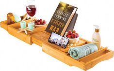 two wooden trays with food and wine on them, one holding a book while the other holds a glass of wine