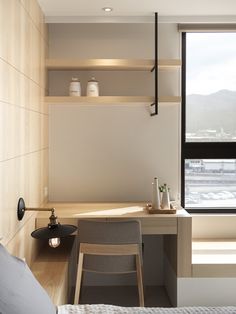 a bedroom with a desk and chair next to a window