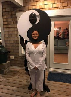 a woman standing in front of a giant yin sign