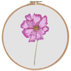 a pink flower is shown in a cross stitch pattern