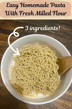 the ingredients for homemade pasta with fresh milled flour in a white bowl on a wooden table