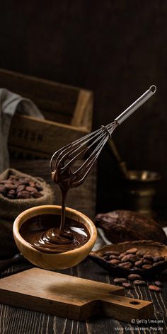 chocolate sauce being poured into a wooden bowl