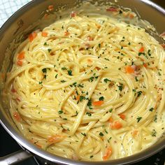 a pot filled with pasta and vegetables on top of a stove