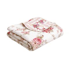 a white blanket with pink flowers on it and a red stripe down the middle is folded in half