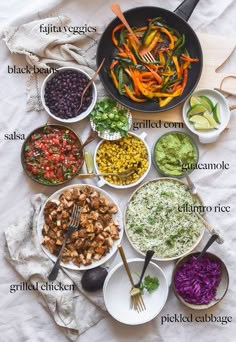 a table topped with bowls filled with different types of food