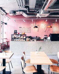 the interior of a restaurant with tables, chairs and food items on the counter area