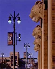 the lights are on and there is a bear statue in front of the street light