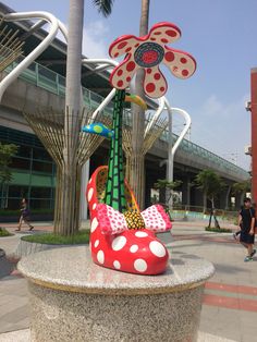 there is a statue in the shape of a flower with polka dots on it and a pinwheel