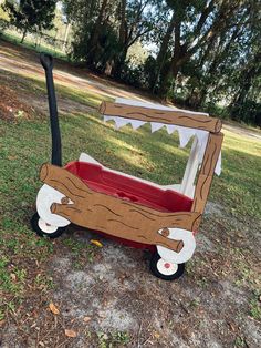 a wagon made out of cardboard sitting in the grass