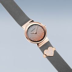 a women's watch with two hearts on the strap