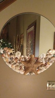 a mirror that has shells and starfish on it