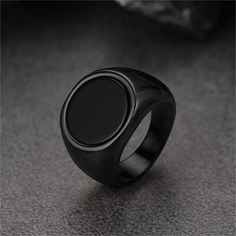 a black ring sitting on top of a table