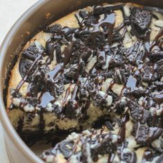 a cookie cake with oreo cookies and chocolate drizzled on top