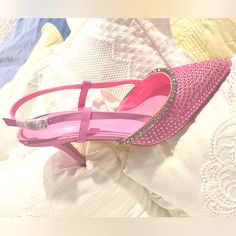 Add Some Glam To Your Casual Looks With These Shiny Heels! Our Sorrel Kitten Heels In Baby Feature An All Pink Fabrication, A Pointed Toe, Rhinestone Studding, And An Adjustable Ankle Strap. Style These With Your Favorite Casual Outfit To Add Some Major Flair To The Whole Look! Pink Slingback Pumps With 4-inch Heel, Pink Ankle Strap Slingback Pumps For Spring, Feminine Pink Ankle Strap Slingback Pumps, Pink Chic Slingback Pumps With 4-inch Heel, Pink Synthetic Ankle Strap Slingback Sandals, Pink Slingback Pumps With 4-inch Heel And Ankle Strap, Pink Ankle Strap Slingback Sandals In Synthetic, Pink Slingback Heels In Synthetic Material, Pink Synthetic Slingback Heels