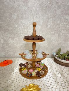 a three tiered tray filled with donuts and pastries on top of a table