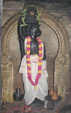 the statue is decorated with flowers and garlands