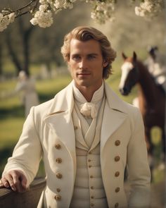 a man in a white coat standing next to a horse