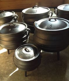 many pots and pans are sitting on the floor