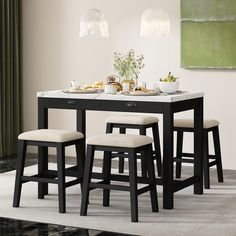 a dining table with four stools in front of it