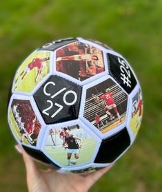 a person holding a soccer ball with pictures on it