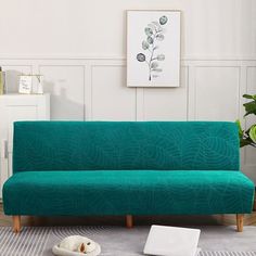 a green couch sitting on top of a white rug