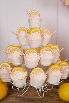 cupcakes are arranged in white baskets with lemons