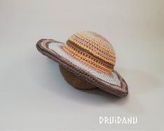 a crocheted hat sitting on top of a white table