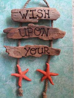 a wooden sign that says wish upon your starfish and two little fish on it