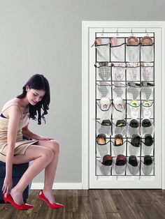 a woman sitting on a stool in front of a shoe rack