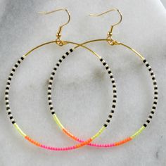 You asked for bigger beaded hoops and Libby & Smee answered! These dangly hoop earrings are the pieces you'll grab every day when you want a little something fun without a lot of fuss. Bonus: They look great dressed up or super casual. Pattern — NEON: black, ivory, neon pink, neon orange and neon yellow beaded hoops with tiny glass seed beads gold-plated stainless steel ear wire hooks and beading wire lead-free and nickel-free comes with plastic earring back for security available in two lar Black And White Beaded Earrings, White Beaded Earrings, Hoop Earrings Big, Boho Wedding Earrings, Plastic Earrings, Earrings Big, Long Tassel Earrings, Earring Cards, Beading Wire